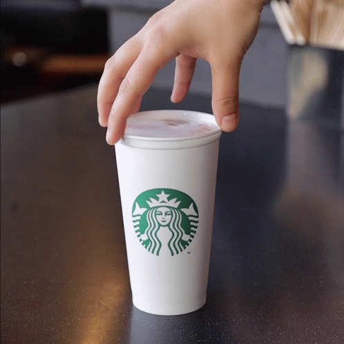 Hand Reaching Into Starbucks Cup