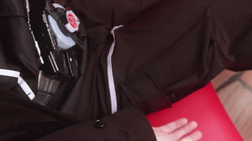 Hand Reaching Toward Black Shirt With Red K