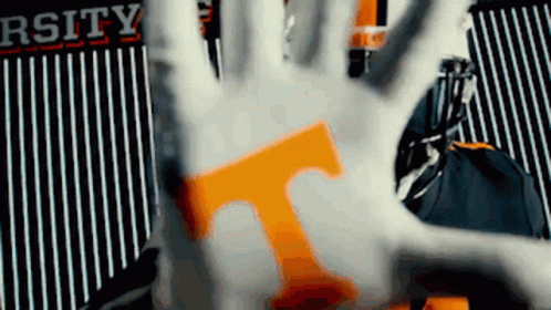 Hand With T In Front of Rsity Sign