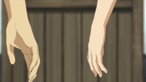 Hands Holding Each Other in Front of Wooden Fence