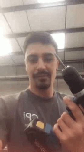 Handsome Guy Showing His Handheld Drill GIF