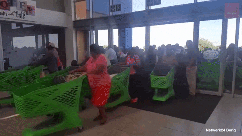 Happy Black Friday People Entering Store With Carts GIF