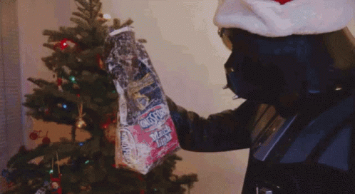 Happy Christmas Harry Black Mascot Giving Gifts GIF