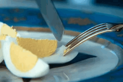 Hard Boiled Egg Cut in Half With Knife and Fork