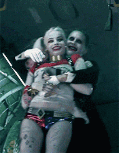 Harley Quinn And The Joker Are Posing For A Picture Together GIF