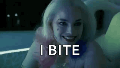 Harley Quinn From Suicide Squad Is Smiling And Says `` I Bite '' While Sitting In A Bathtub . GIF