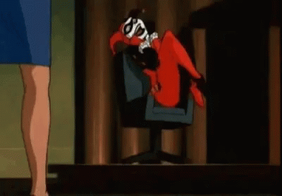 Harley Quinn Is Laying On Her Back In A Chair While A Woman Stands Next To Her . GIF