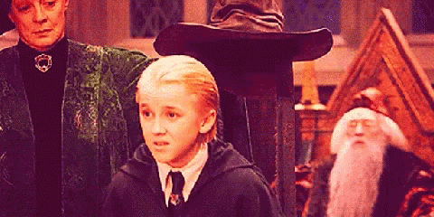 Harry Potter Characters Are Standing In A Room With A Wizard Hat In The Background GIF