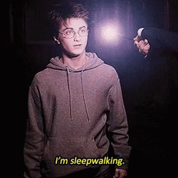 Harry Potter Is Holding A Wand And Says I 'M Sleepwalking . GIF