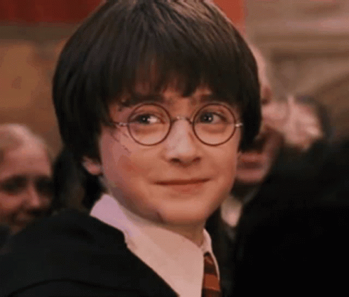 Harry Potter Wearing Glasses And A Suit And Tie Is Smiling . GIF