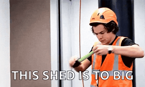 Harry Styles In Hard Hat And Safety Vest Measuring Wood GIF