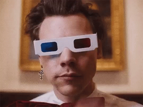 Harry Styles Is Wearing A Pair Of 3D Glasses In Front Of A Painting . GIF