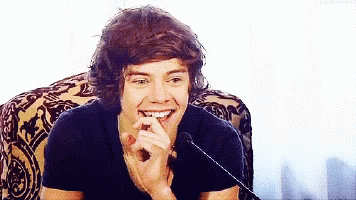 Harry Styles Smiling in Chair