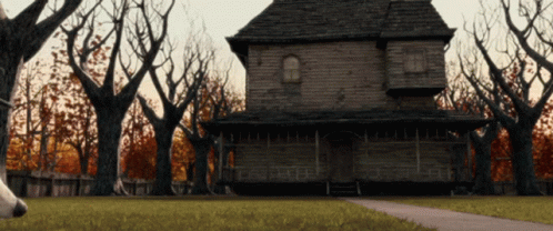 Haunted House Surrounded By Trees And Fence GIF