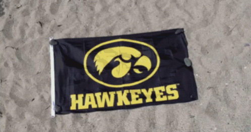 Hawkeyes Flag Laying on Sand on Beach