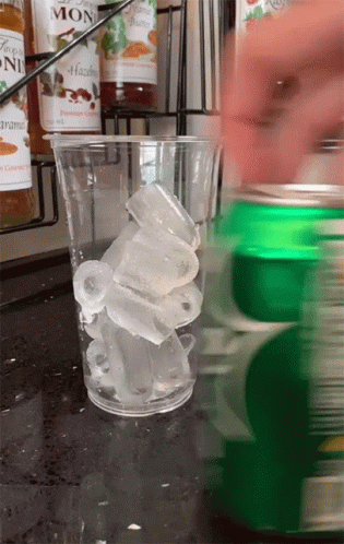 Hazelnut Syrup Pouring Into Glass Of Ice Cubes GIF
