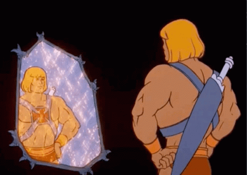 He Man Is Looking At Himself In A Mirror While Holding A Sword GIF