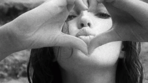 Gorgeous Lady Blows Kiss Inside Heart Hands GIF