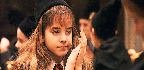 Hermione Granger From Harry Potter Is Wearing A Hat And Tie And Is Holding Her Hands Together . GIF