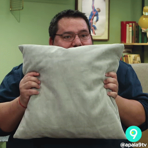 Hiding Meme Guy Behind Small Pillow GIF