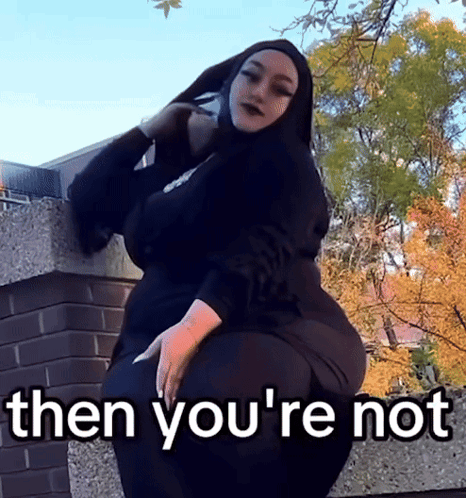 Hijabi Woman on Wall Says Then You're Not