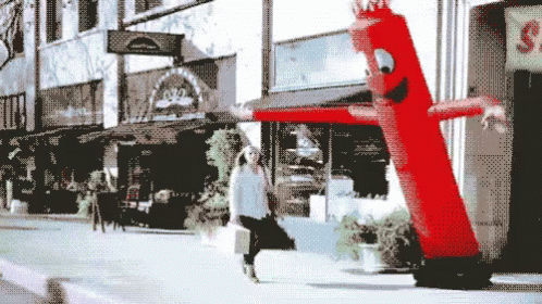 Hilarious Inflatable Tube Man Harassing Lady GIF