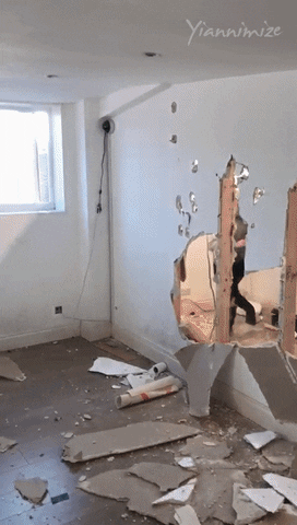 Hilarious Prankster Bangs Head Against Wall GIF