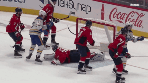 Hockey Game In Front Of Coca Cola Sign GIF