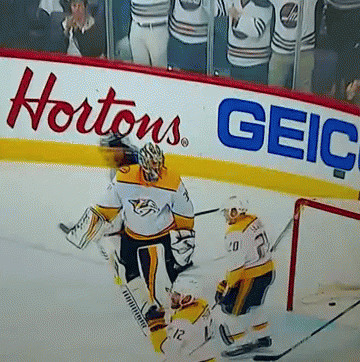 Hockey Game In Front Of Hortons Geico Sign GIF