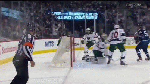 Hockey Game in Front of Jets Sign