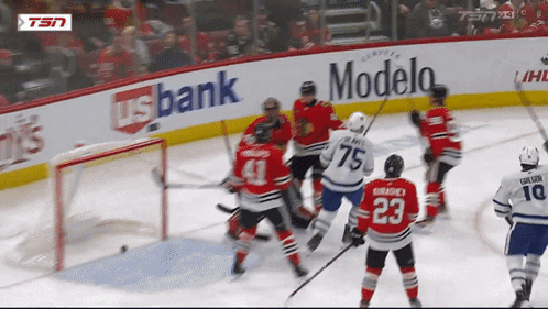 Hockey Game in Front of Modelo Sign