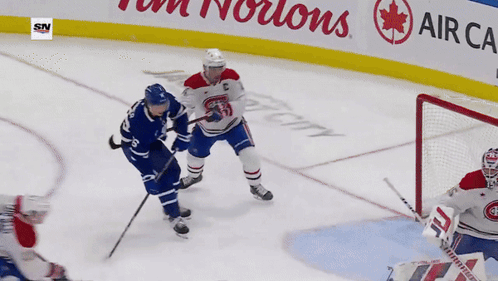 Hockey Game In Front Of Tim Hortons Sign GIF