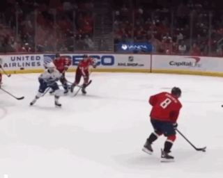 Hockey Game in Front of United Airlines Ad