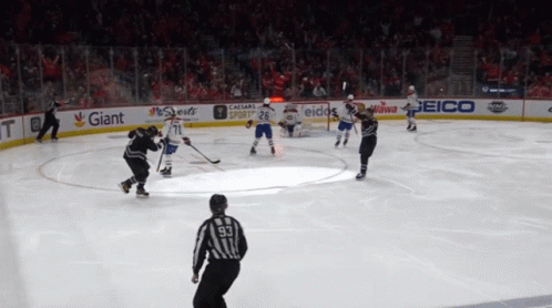 Hockey Game in Stadium With Giant and Geico Ads