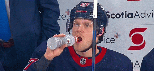 Hockey Player Drinking Water from Gatorade Bottle