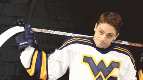 Hockey Player Holding Bauer Hockey Stick Over Shoulder