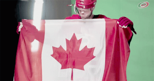 Hockey Player Holding Canadian Flag in Front of Green Screen