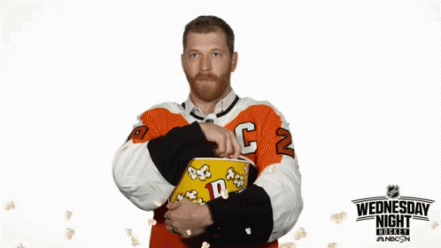Hockey Player Holding Popcorn Wednesday Night Sign