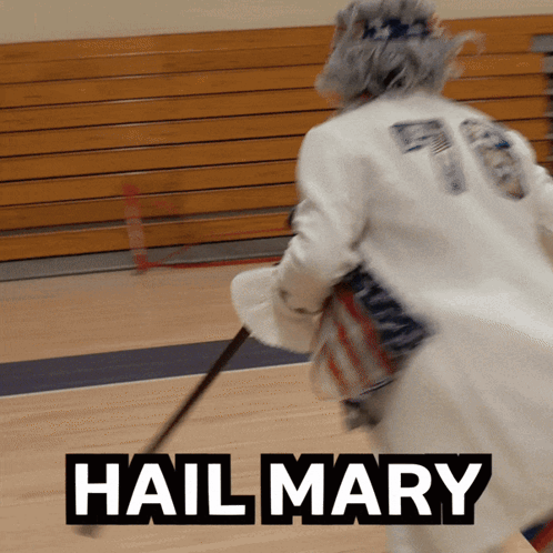 Hockey Player Holding Stick With Hail Mary