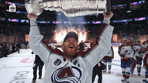 Hockey Player Holding Trophy