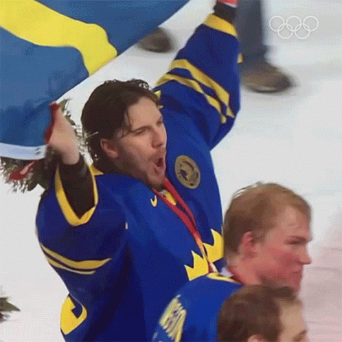 Hockey Player in Blue and Yellow Jersey Holding Flag