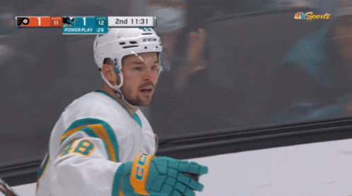 Hockey Player in Front of Powerplay Scoreboard