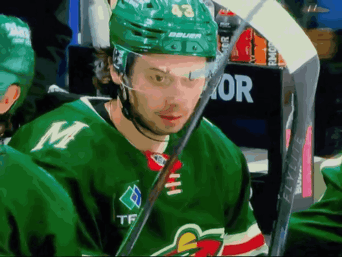 Hockey Player in Green Jersey with M