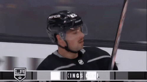 Hockey Player in Kings Helmet Holding Hockey Stick
