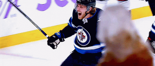 Hockey Player in Maple Leaf Jersey Celebrating Goal