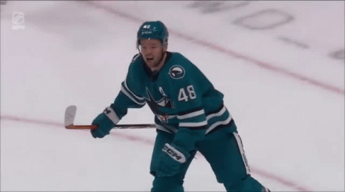 Hockey Player in Sharks Jersey Raising Arms
