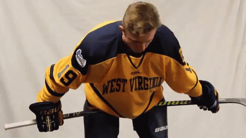 Hockey Player in West Virginia Jersey Holding Stick