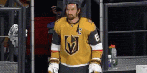Hockey Player in Yellow Jersey and Gloves in Locker Room