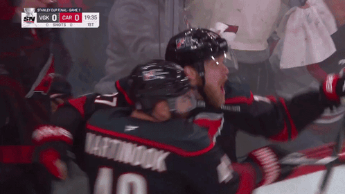 Hockey Player Number 10 Hugging Another Player GIF