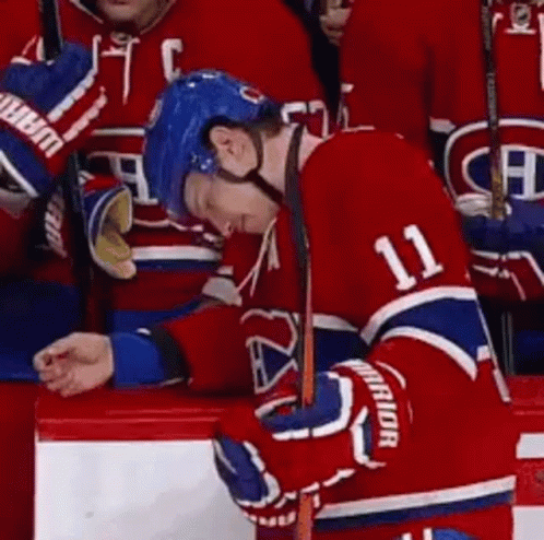 Hockey Player Number 11 Leaning on Bench